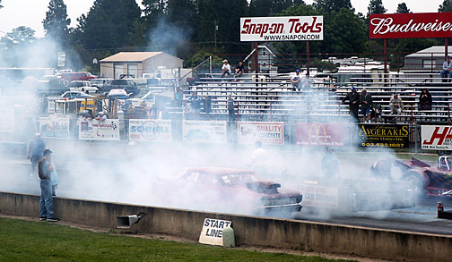 a Chevy
muscle car, I believe a Chevelle Malibu, burning lots of rubber at the starting line
