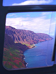 Helicopter above the spectacular reds and blues of the Na Pali Coastline